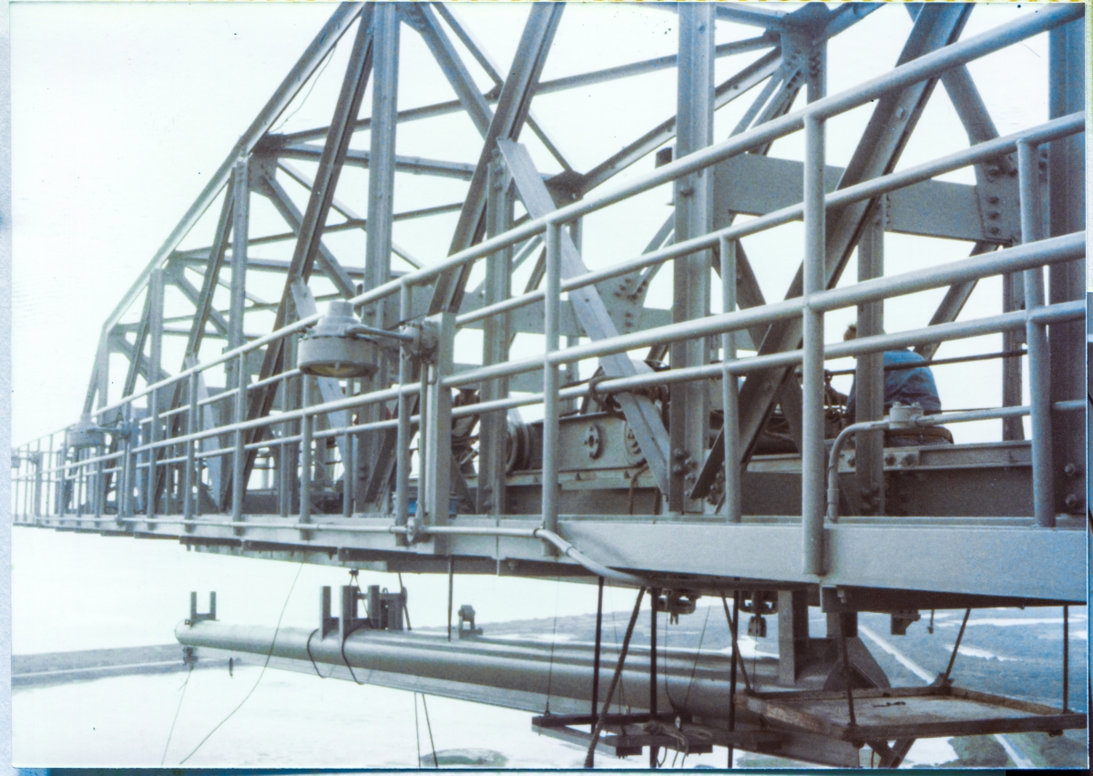 Image 060. Union Ironworkers from Local 808, working for Ivey Steel at Space Shuttle Launch Complex 39-B, Kennedy Space Center, Florida, prepare to connect the TPS Inspection Spider Basket Trolley Support Extensible Pipe Boom to the underside of the Hammerhead Crane, 300 feet above the bottom of the Flame Trench. This thing was a breathtakingly bad idea, and at least on Pad B, it was never used, even once, but they somehow managed to get even that part of things wrong too, and before they came to their senses, it got completely and fully furnished and installed before they then directed us to undo everything we had done, remove it from the tower, cut it into pieces, and haul those pieces over to the scrap yard at Ransom Road, and therein lies quite the Kafkaesque tale of NASA bureaucracy run amok. Photo by James MacLaren.